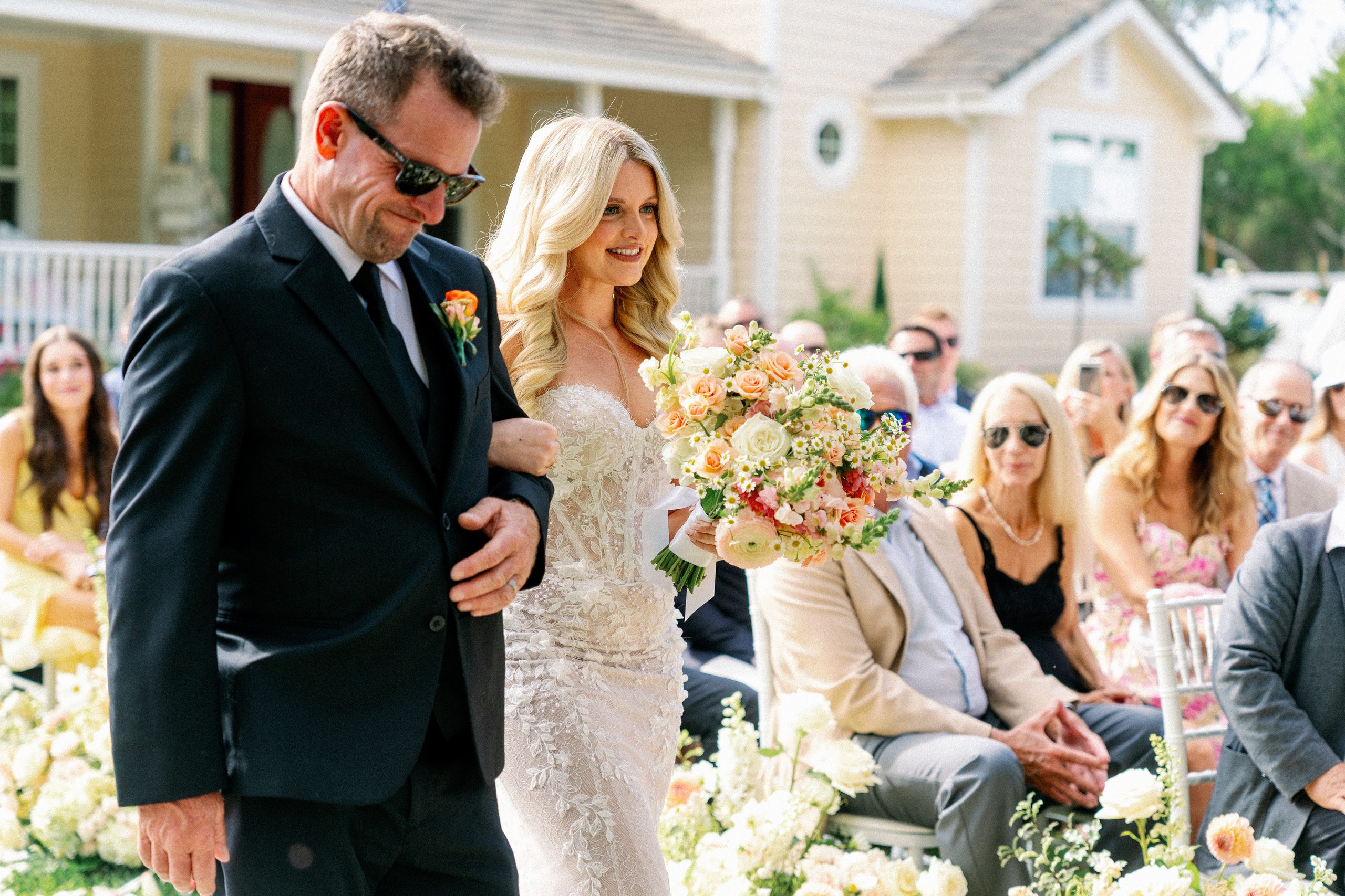 Father walking the bride down the aisle at a backyard wedding in Olivenhain