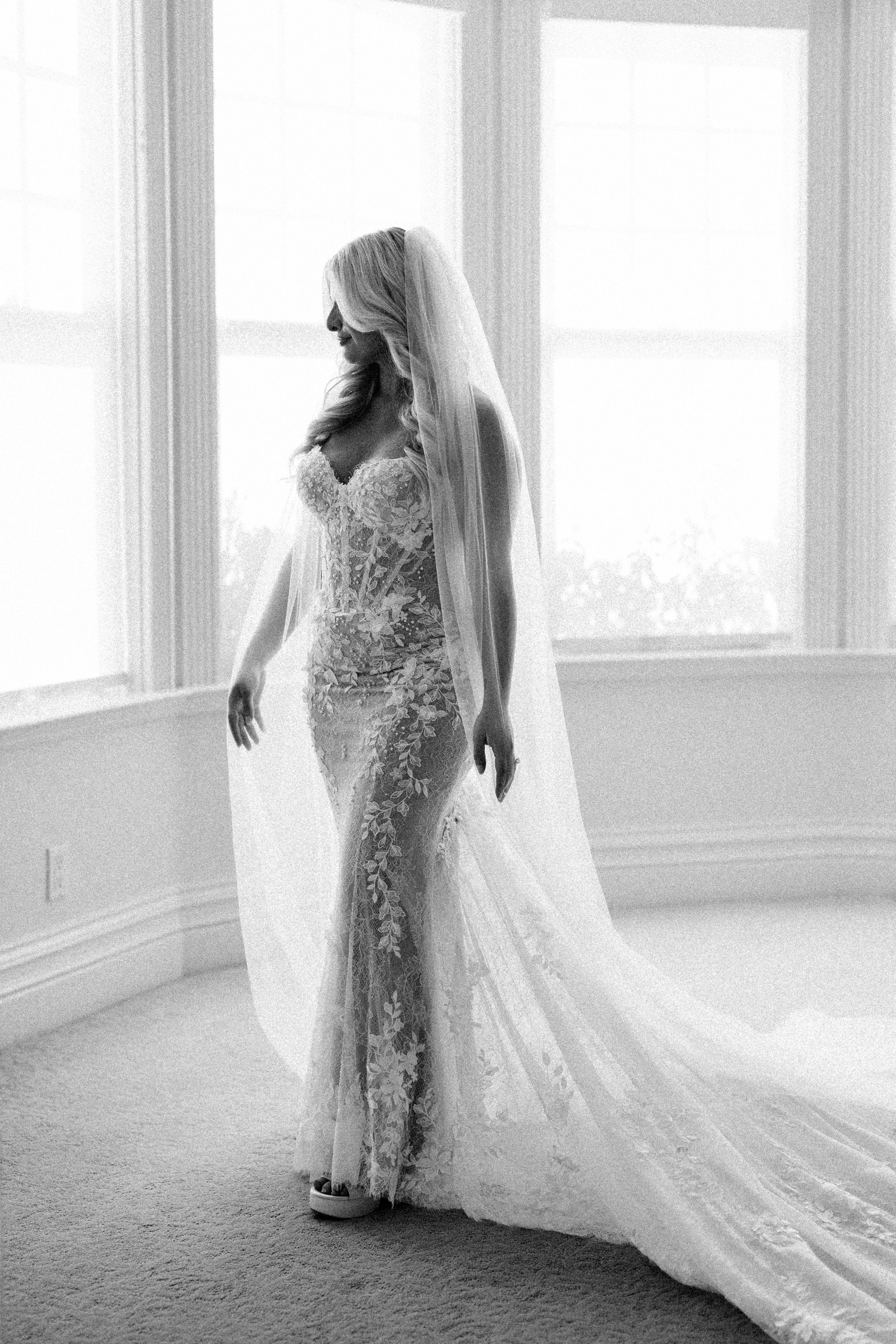 Black and white bridal portrait in soft window light before an Olivenhain backyard wedding