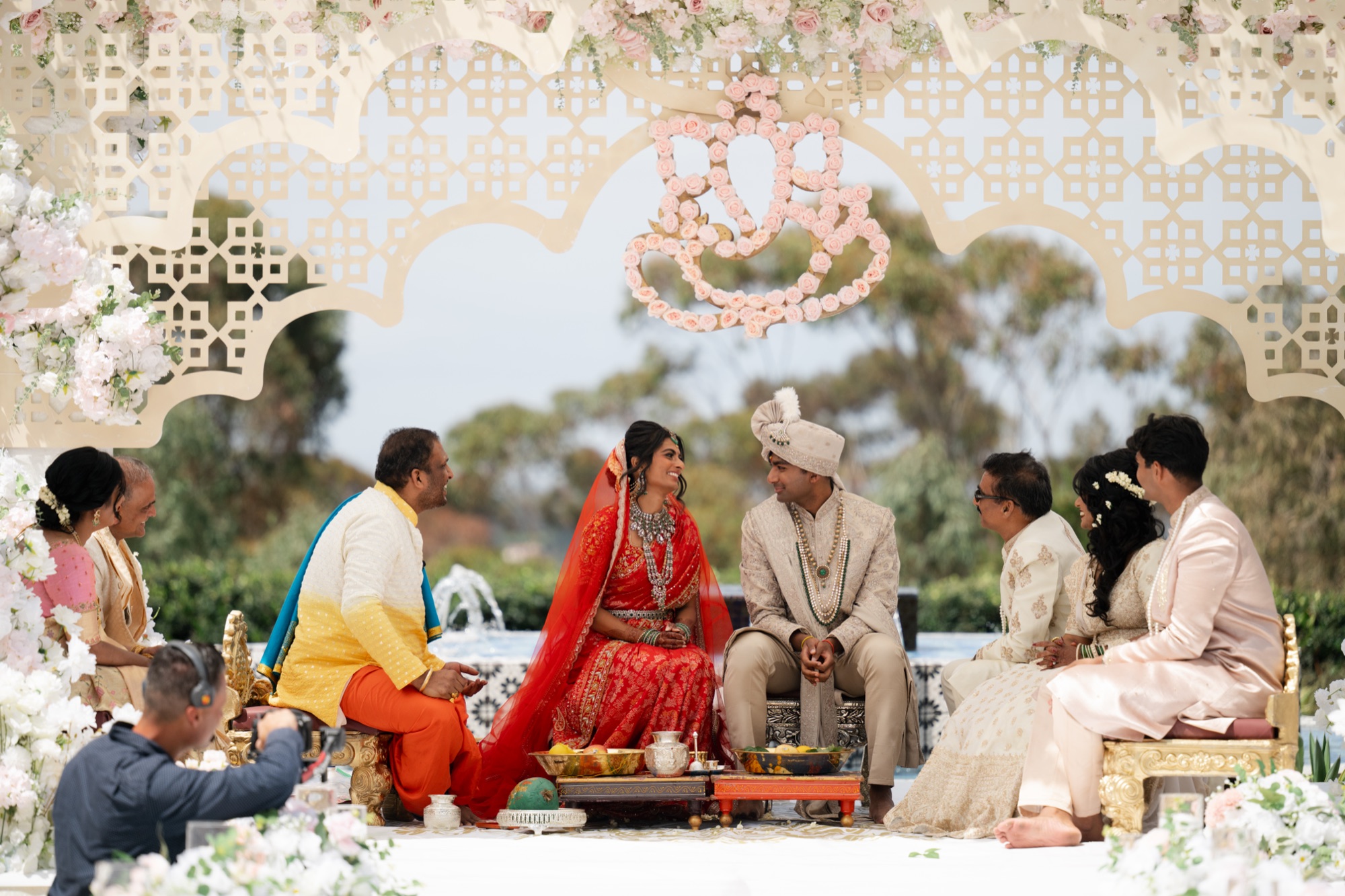 Hindu wedding ceremony under a floral mandap with Ganesh backdrop at Park Hyatt Aviara, Carlsbad